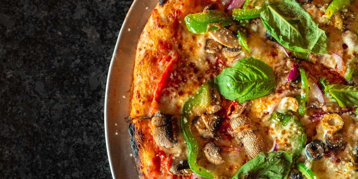 Our menu offers hand-tossed pizza cooked to perfection in our wood-fired brick oven, savory salad creations, and tasty cheese breads. Order some of our pizza for your next corporate event and find out why we were named one of Birmingham's top must-try lunch & dinner spots! - Post Office Pies