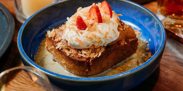 Slice of Coconut & Golden Raisin Cuatro Leches Cake