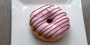Pink Frosting Donut With Chocolate Drizzle